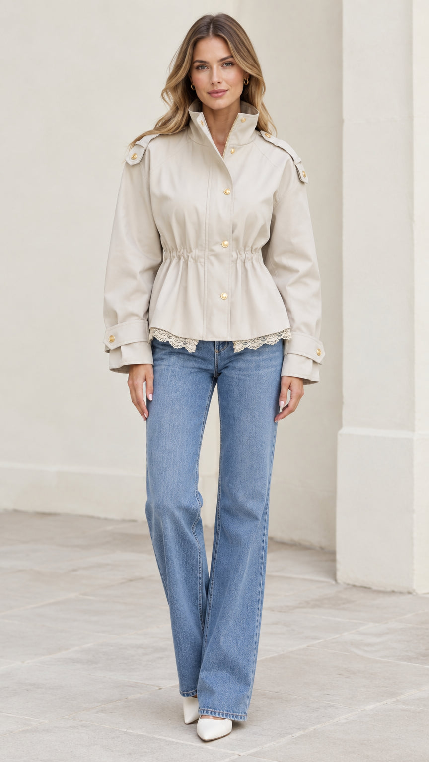 Full front view of model wearing beige cinched waist utility jacket with lace trim and blue jeans