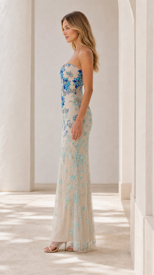 Side angle view of champagne floral embellished maxi formal dress