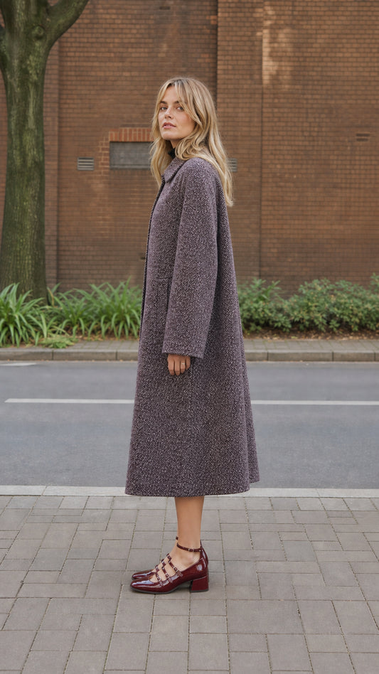 Side profile view of women's longline textured overcoat in Plum