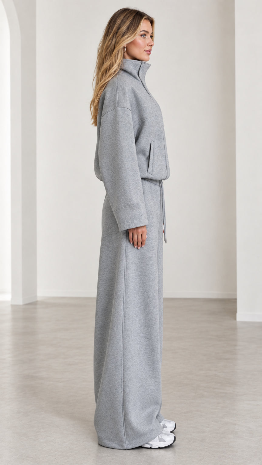 Side profile view of women's heather gray relaxed wide leg sweatpants set
