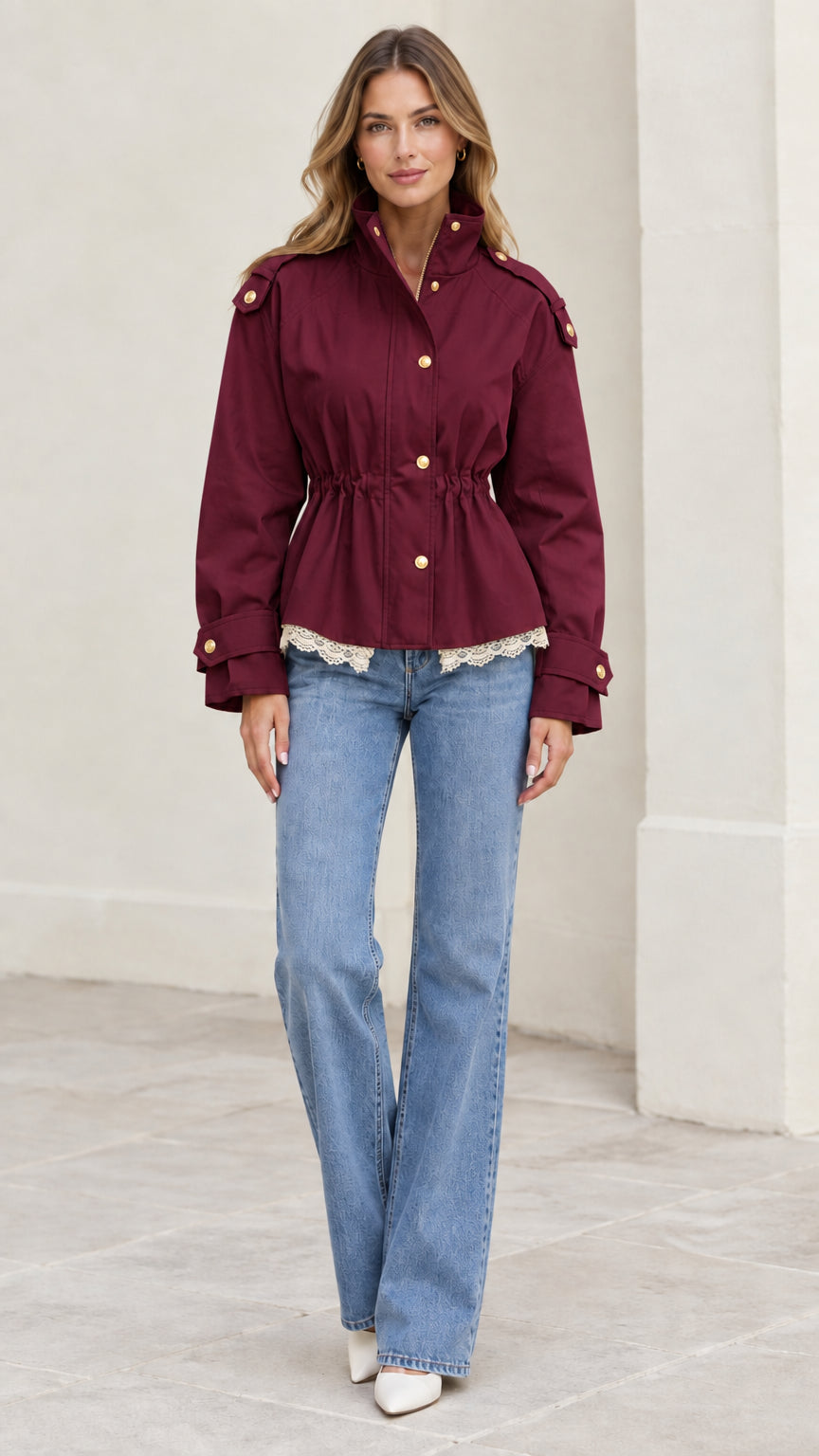 Model wearing burgundy wine red cinched waist utility jacket with gold snap buttons