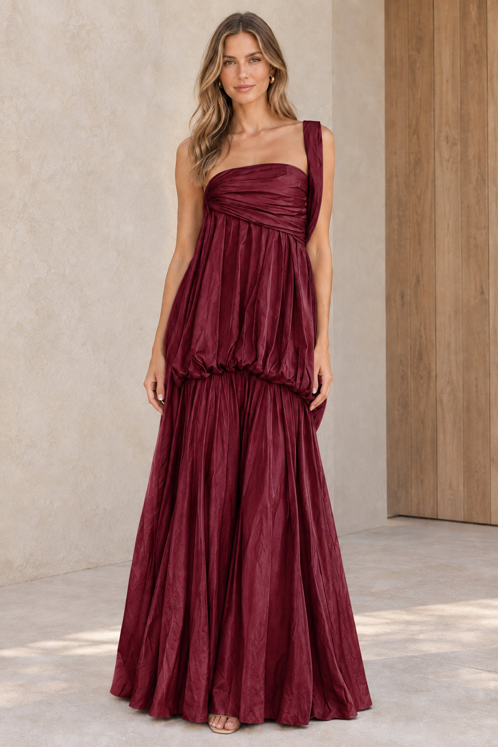 Front view of burgundy wine one-shoulder pleated maxi evening dress