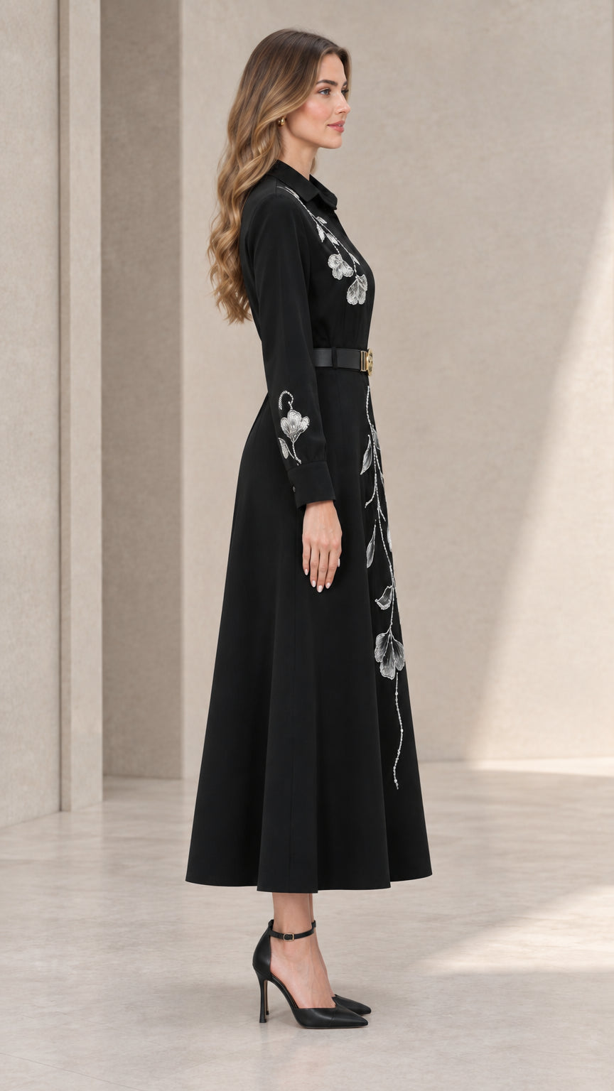 Side profile view of black embroidered A-line midi shirt dress