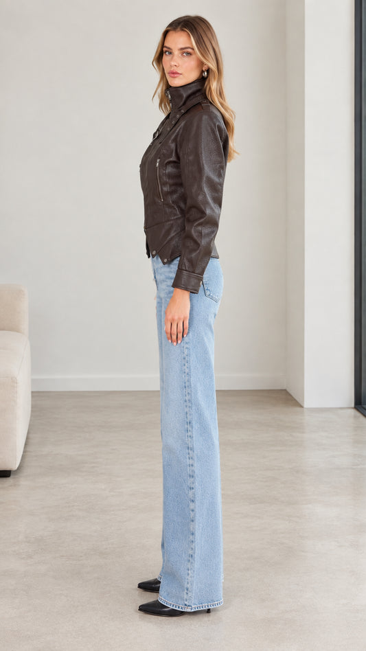 Side profile of model wearing dark brown faux leather moto jacket