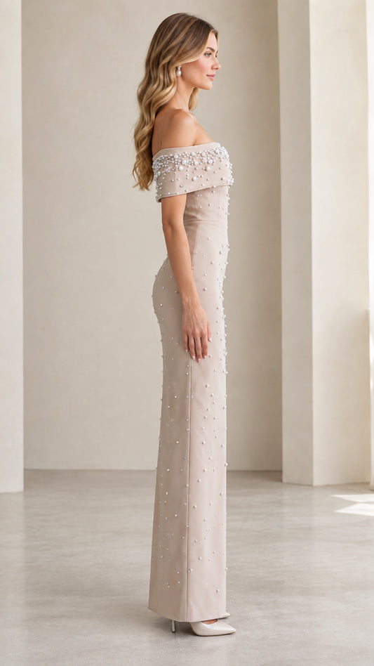 Side profile view of Champagne off-the-shoulder formal gown with pearl beading