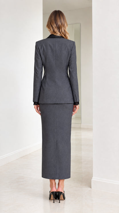 Back full-length view of fitted charcoal grey blazer and ankle-length column skirt