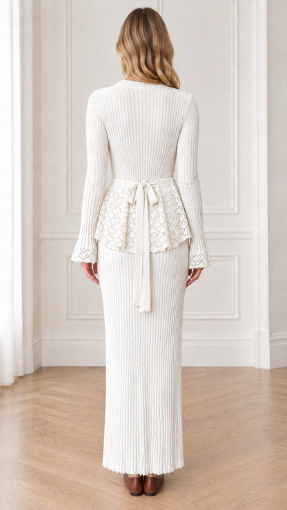 Back view of cream ribbed knit maxi dress showing waist tie ribbon and lace peplum