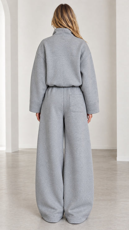 Back view of women's heather gray two-piece tracksuit with pocket detail