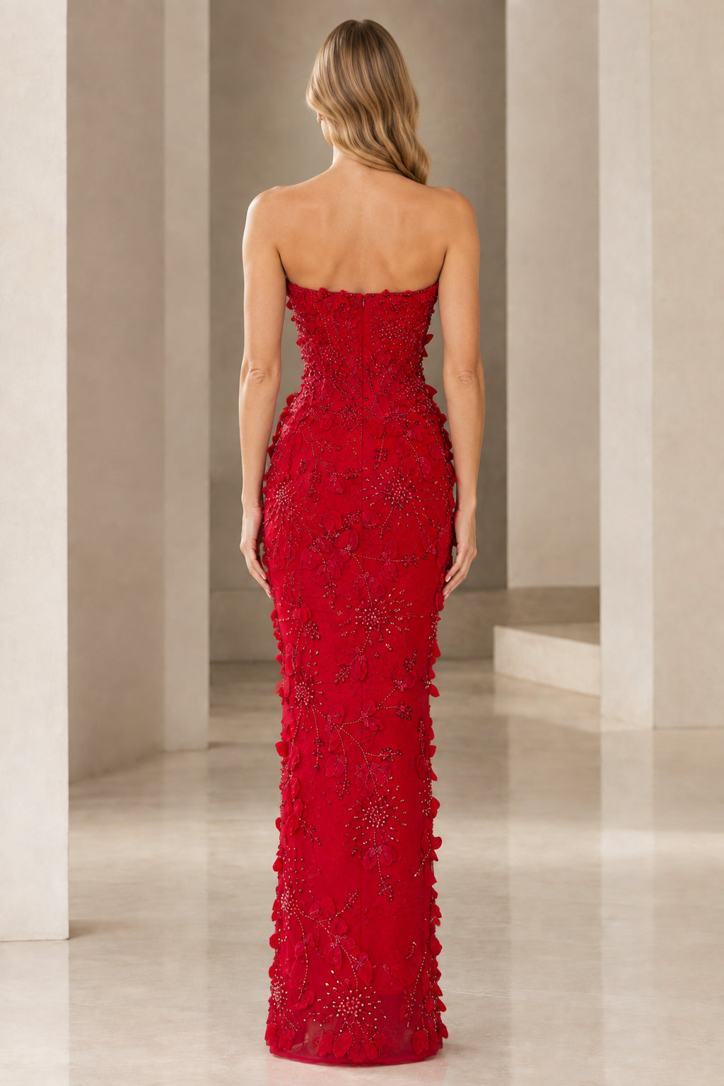 Back view of model in red strapless column gown