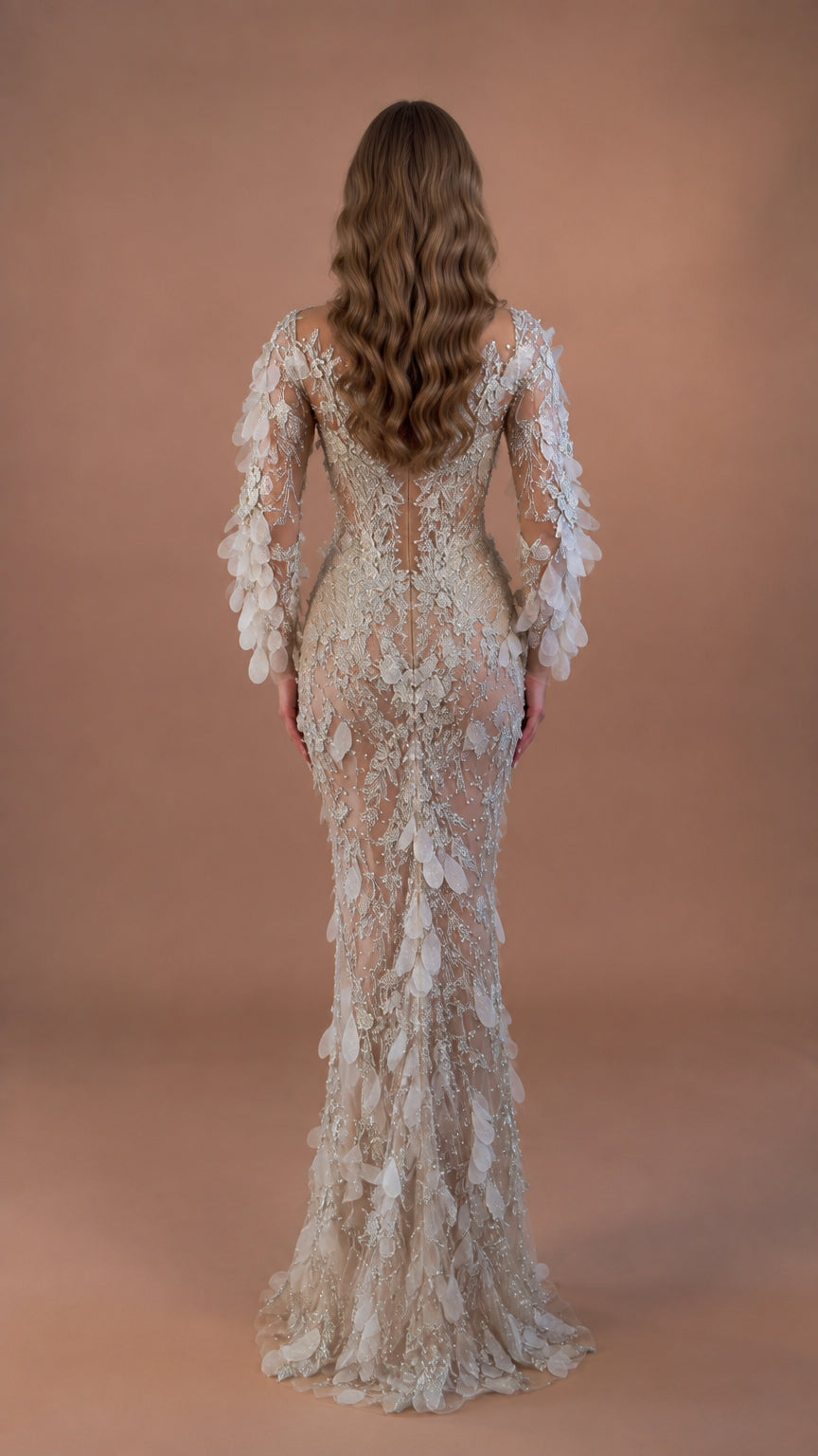Back view of model in sheer back Champagne Silver mermaid gown with beaded details