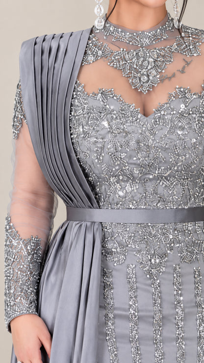 Close up of intricate beadwork and pleated shoulder drape on illusion neckline