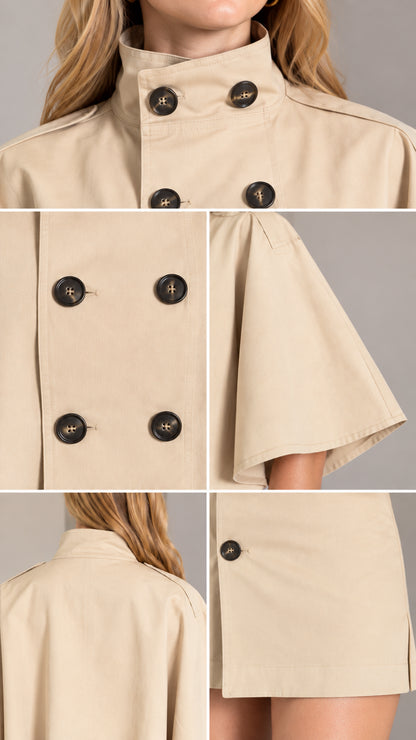 Close-up details of collar buttons, cape sleeve tailoring, and skirt hem