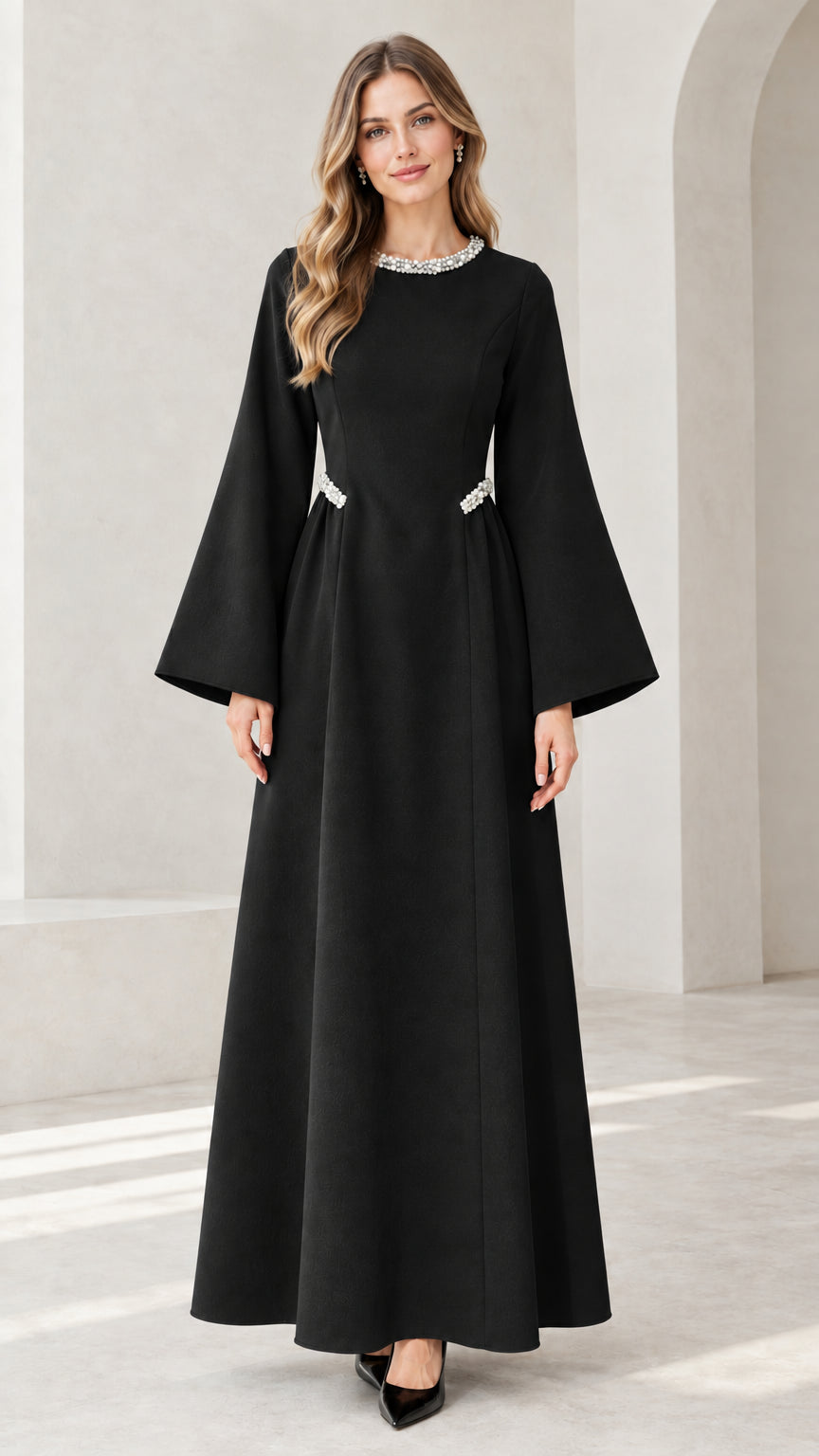 Front view of model wearing black embellished flare sleeve maxi dress