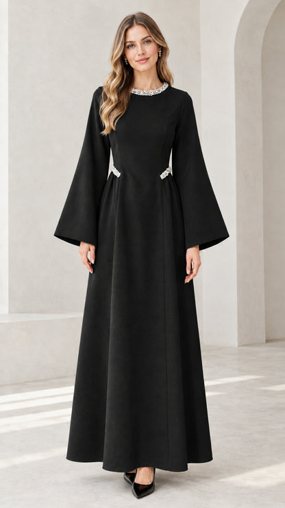 Front view of model wearing black embellished flare sleeve maxi dress