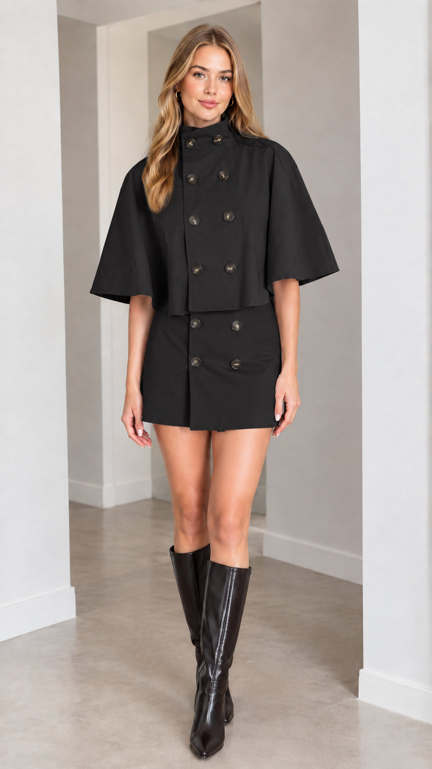 Model wearing black double-breasted capelet and mini skirt two-piece set