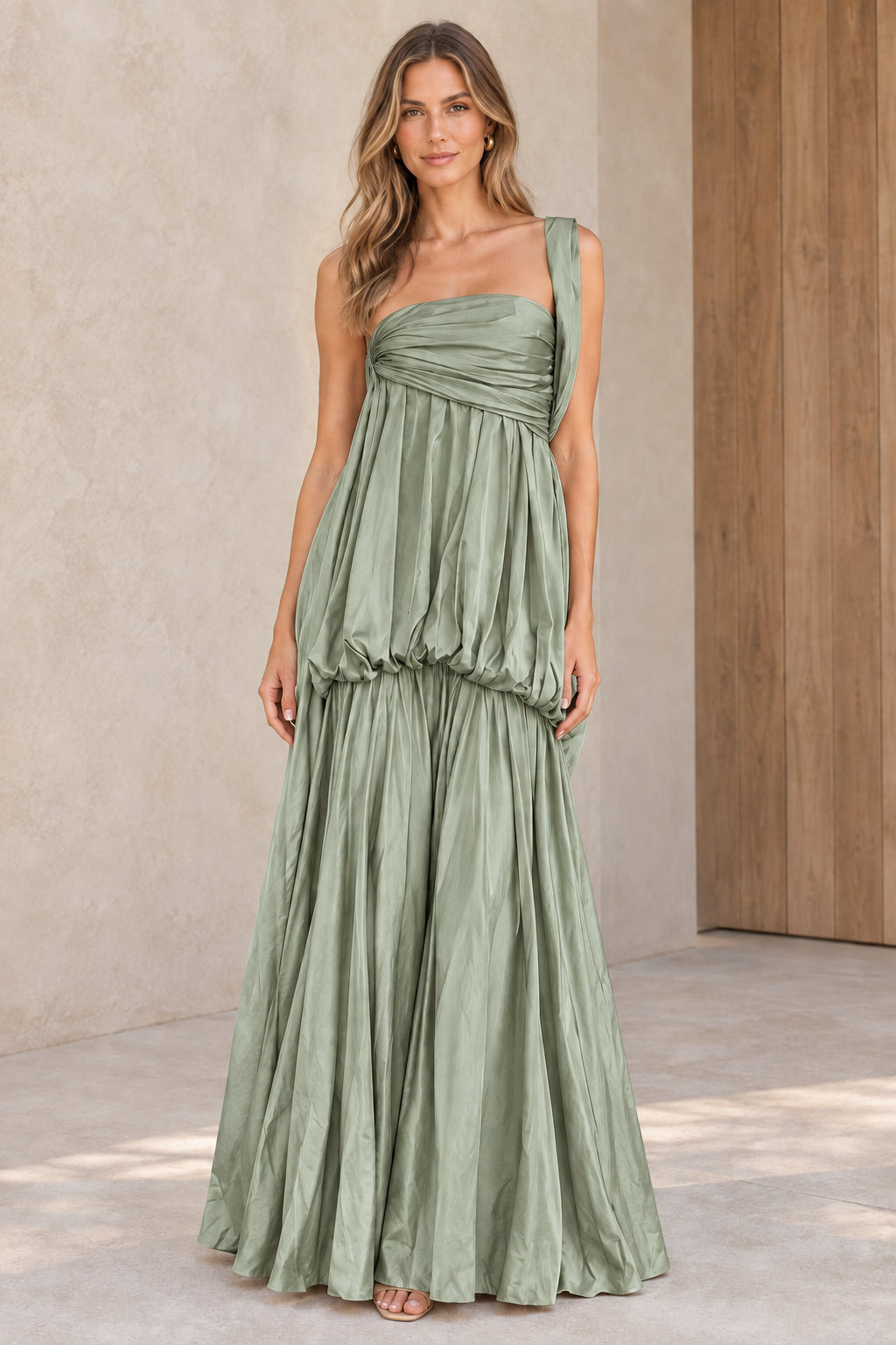 Front view of sage green one-shoulder pleated drop-waist maxi dress