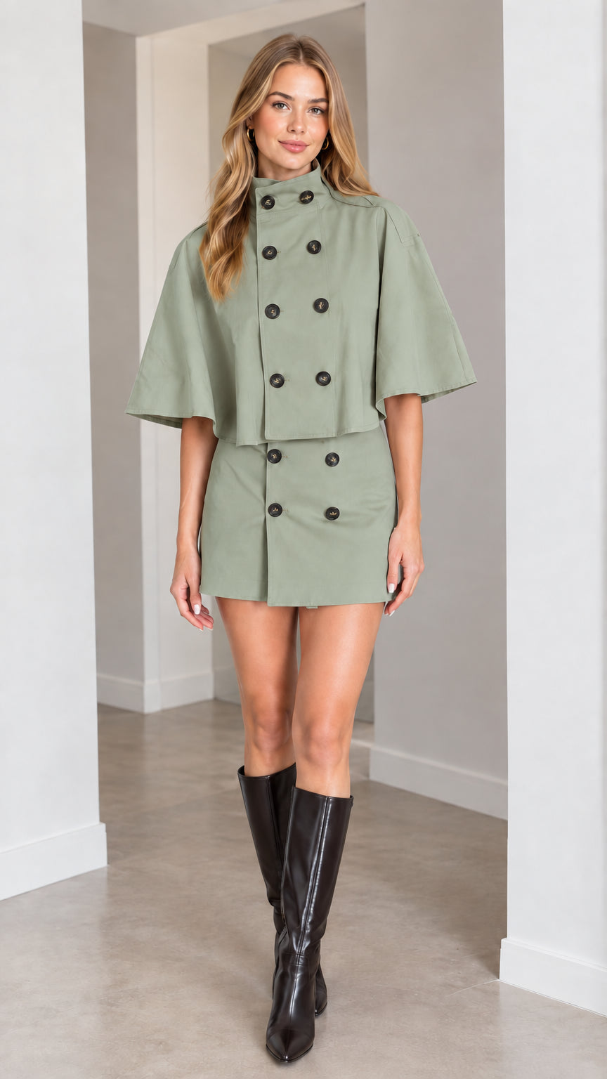 Model wearing sage green double-breasted cape top and mini skirt set