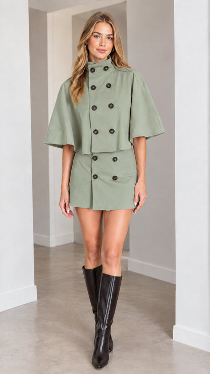 Model wearing sage green double-breasted cape top and mini skirt set